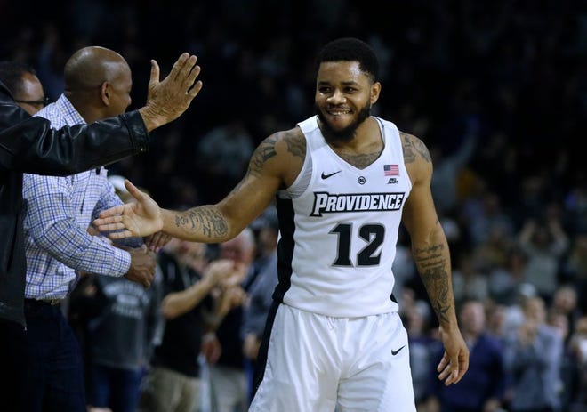 Providence’s Luwane Pipkins celebrates Wednesday’s win over Xavier with fans in the game’s closing seconds.