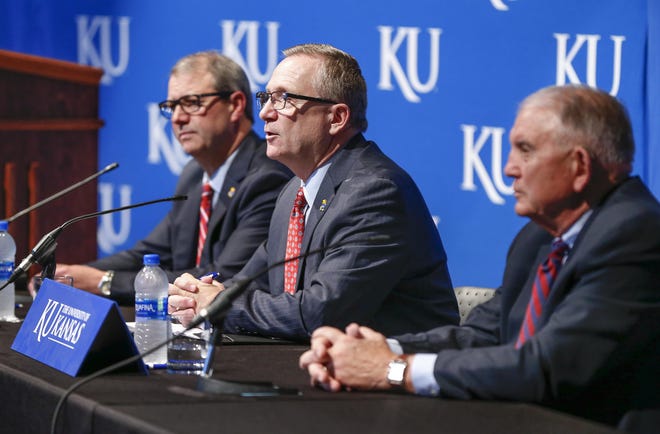 Jeff Long, the University of Kansas' athletic director, center, along with Chancellor Douglas Girod, left, issued a joint statement Thursday saying the university is “deeply troubled” by findings of an internal investigation into a massage therapist who worked as an independent contractor with female student-athletes. [File photo/The Capital-Journal]