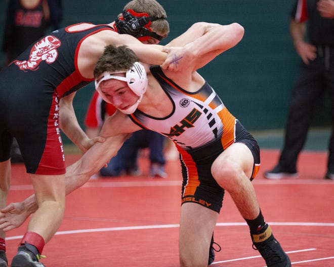 Mosley’s Nick Hejke, right, goes for a leg in action with Bay High’s Corban Cherry during a match at The Bash wrestling tournament on Dec. 4, 2020. [MIKE FENDER/FOR THE NEWS HERALD]