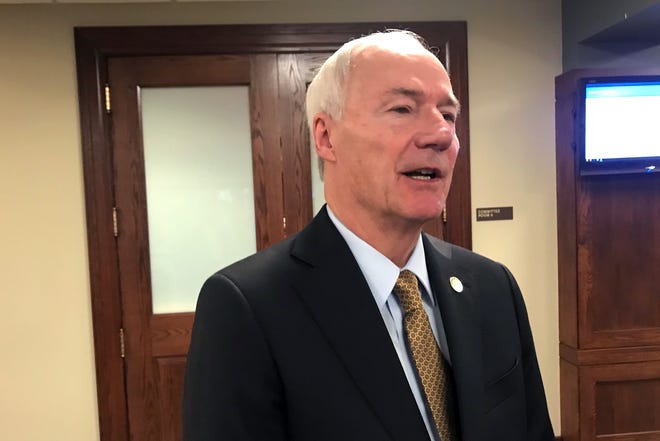 Arkansas Gov. Asa Hutchinson talks to reporters in Little Rock on Wednesday, March 4, 2020 after presenting his proposed budget for the coming fiscal year. [AP Photo/Andrew DeMillo]