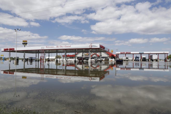 A Sapp Bros. gas station in Percival, Iowa, in May stands in floodwaters from the Missouri River. Republican senators from four states that have seen severe flooding from the Missouri River are backing legislation that would require the U.S. Army Corps of Engineers to change its management of the river to reduce flooding risk. [Nati Harnik/Associated Press]