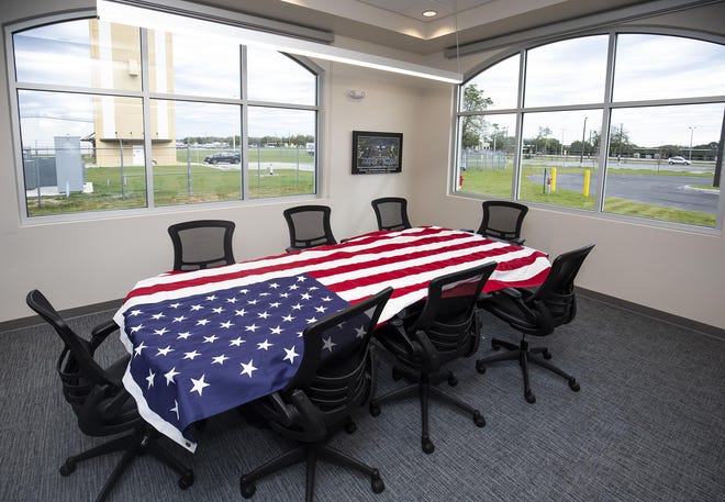 An American flag waits to be folded while resting on a conference table during a media tour of the new terminal at the Ocala International Airport on Feb. 26. The flag was too big for the flagpole. [Doug Engle/Gannett Florida]