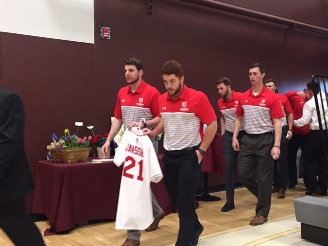 A contingent representing the Bradley University baseball team enters the gym at Princeville High School for Saturday's visitation for Mitchell Janssen. The 22-year-old , who earned athletic and academic honors with the team before graduating in 2019, had worn jersey No. 21. Janssen died Tuesday when the plane he was piloting crashed near Lincoln, also killing his two passengers. [PHIL LUCIANO/JOURNAL STAR]