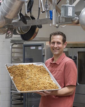 Brian Neyenhouse, owner of Nutty Bird Granola, holds a tray of his original recipe at the Worcester Regional Food Hub. [T&G Staff/Rick Cinclair]