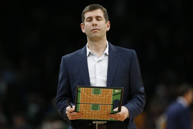 Boston Celtics head coach Brad Stevens holds his clipboard during a timeout in the fourth quarter of a game against the Utah Jazz on March 6, 2020, in Boston. [AP File Photo/Winslow Townson]