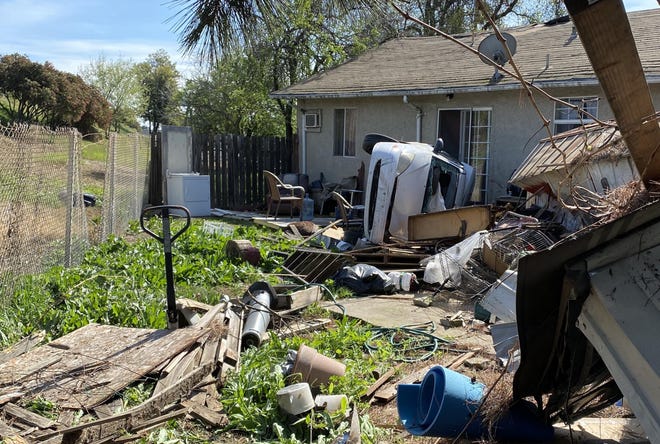 A small car came off Interstate 5 Monday morning, crashed through two backyards and landed just inches from a home in west Stockton. The driver sustained minor injuries, but no residents were injured. [JOE GOLDEEN/THE STOCKTON RECORD]