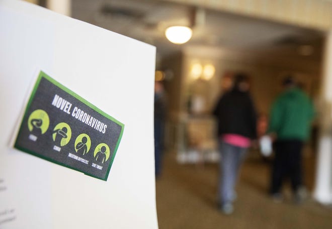 An information board on the new coronavirus is displayed in the lobby of the South Shore Rehabilitation and Skilled Care Center in Rockland, Mass. Avoid scams related to the coronavirus by being aware of warning sights. [DAVID GOLDMAN / ASSOCIATED PRESS]