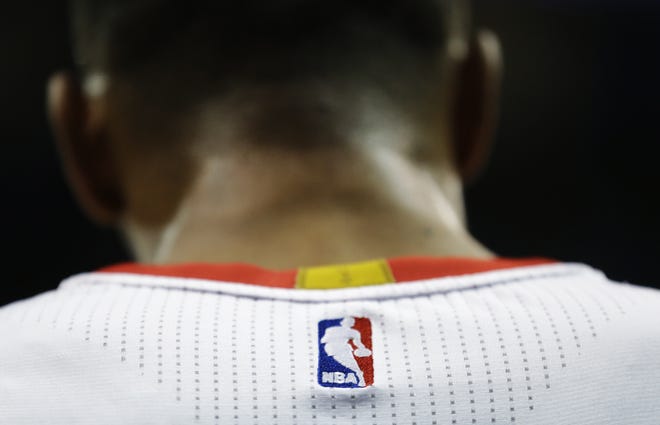 A logo is seen on the back of the jersey of Atlanta Hawks' Thabo Sefolosha, of Switzerland, in the second quarter of an NBA basketball game against the Phoenix Suns Tuesday, April 7, 2015, in Atlanta. (AP Photo/David Goldman)