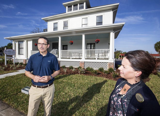 Ken Ausley, left, co-founder of Ambleside School of Ocala, and Principal Jill Romine, right, talk about the new high school campus at 420 SE Watula Ave. on Wednesday. The historic house, known as the Wolf House, was moved to the new location in August. [Doug Engle/Staff photographer]