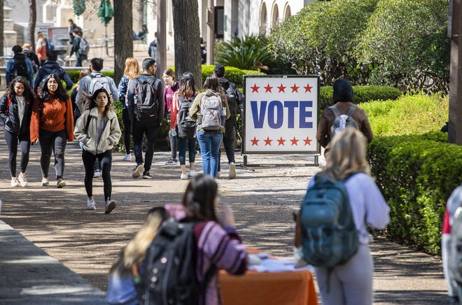 University of Texas students walk by a polling place during early voting in February. [RICARDO B. BRAZZIELL/AMERICAN-STATESMAN]