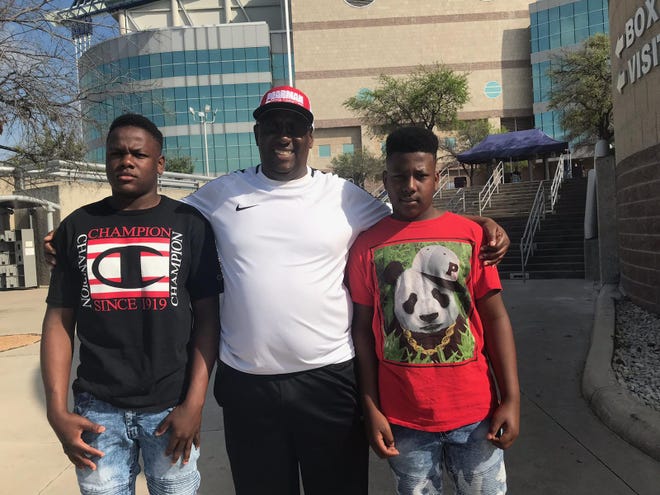 Oliver Sturns of Rusk, with sons Oliver, left, and Jermichael, drove five hours to San Antonio on Wednesday to watch the UIL state basketball tournament, which began Thursday morning. By Thursday afternoon the state tournament had been canceled. [Rick Cantu/American-Statesman]