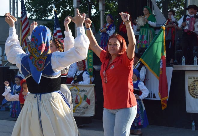 Dulce Matos, at right, president of the New Bedford Day of Portugal Committee dances with members of a folklore group at last year's celebration.