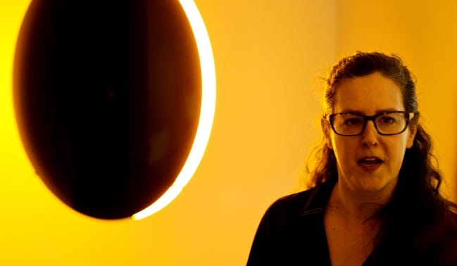 Jennifer Scanlan, curatorial and exhibitions director, talks on March 9 about Olafur Eliasson's "Black glass eclipse," one of a variety of works by international artists in "Bright Golden Haze," the inaugural exhibit at the new Oklahoma Contemporary Arts Center. [Doug Hoke/The Oklahoman]