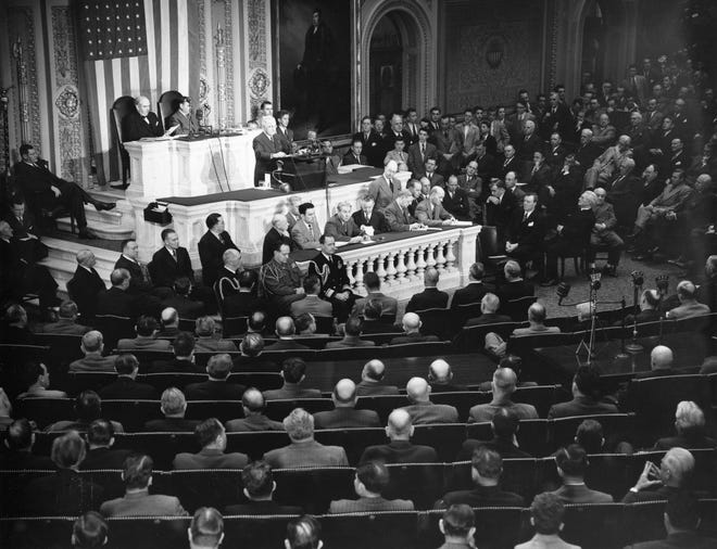 U.S. President Harry S. Truman, standing at podium, addresses a joint session of Congress in the House Chamber on March 12, 1947, in Washington, D.C. President Truman is urging aid for Greece and Turkey. [THE ASSOCIATED PRESS]