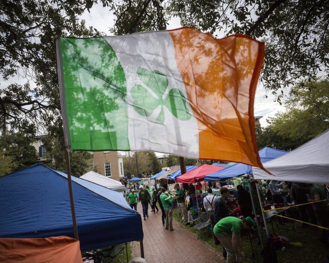 Revelers prepare for the 195-year-old St. Patrick's Day parade on one of the city's historic squares, Saturday, March 16, 2019, in Savannah, Ga. (AP Photo/Stephen B. Morton)