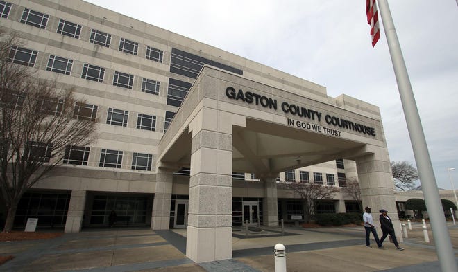 People enter the Gaston County Courthouse on Dr. Martin Luther King Jr. Way in Gastonia on Friday afternoon. While the courthouse will remain open, starting Monday, most cases in Gaston County District and Superior courts will be postponed 30 days. [Mike Hensdill/The Gaston Gazette]