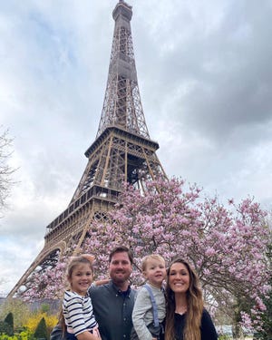 Zack and Sarah Simcox take a family photo with their children, Raelynn and Ryley, in front of the Eiffel Tower. The Port Orange family will be stuck in Paris past the coronavirus travel ban deadline. [Sarah Simcox]