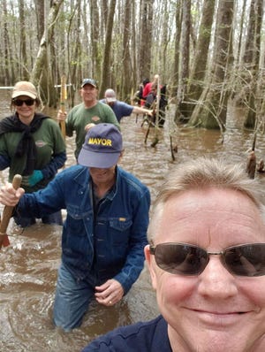 Mayor JB Whitten follows Crestview Area Chamber of Commerce member Ryan Price as they hike with soldiers from the 6th Ranger Training Battalion through swamps near Camp Rudder. [RYAN PRICE | CONTRIBUTED PHOTO]