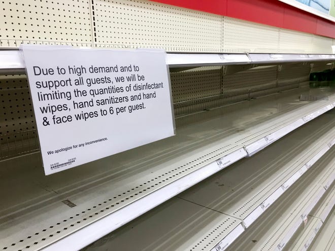 A sign on empty shelves lists limits for wipes and hand sanitizers at Target, 5400 N May Ave., in Oklahoma City, Friday, March 13, 2020. [Nate Billings/The Oklahoman]