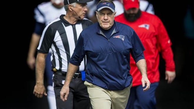 Patriots head coach Bill Belichick takes the field before the start of the game against the Dolphins on Jan. 1, 2017, in Miami. He and his coaches and scouts have been encouraged to work from home for the time being. [The Palm Beach Post, file / Bill Ingram]