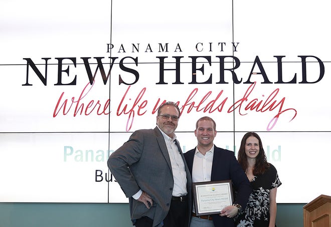 From left, Panama City News Herald Publisher Tim Thompson, Panama City Beach Chamber of Commerce President and CEO Kristopher McLane and Floridian International Adjusters Public Adjuster Hailey Colgate stand for a photo as McLane presents the Business Excellence Award to The Panama City News Herald on Friday at Gulf Coast State College. [PATTI BLAKE/THE NEWS HERALD]