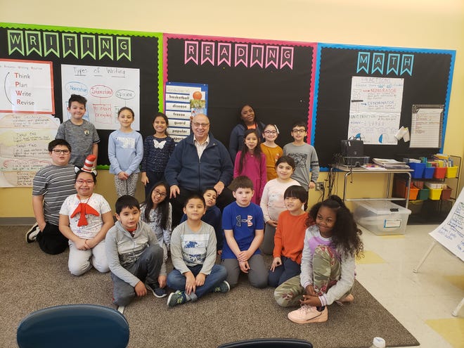 School Committee member Arthur Grabowski reads to Veterans Memorial Elementary School students for an event to celebrate the birthday of Dr. Seuss. Courtesy photo