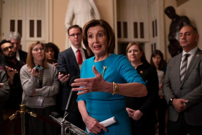 Speaker of the House Nancy Pelosi, D-Calif., makes a statement ahead of a planned late-night vote on the coronavirus aid package deal at the Capitol in Washington, Friday, March 13, 2020.
