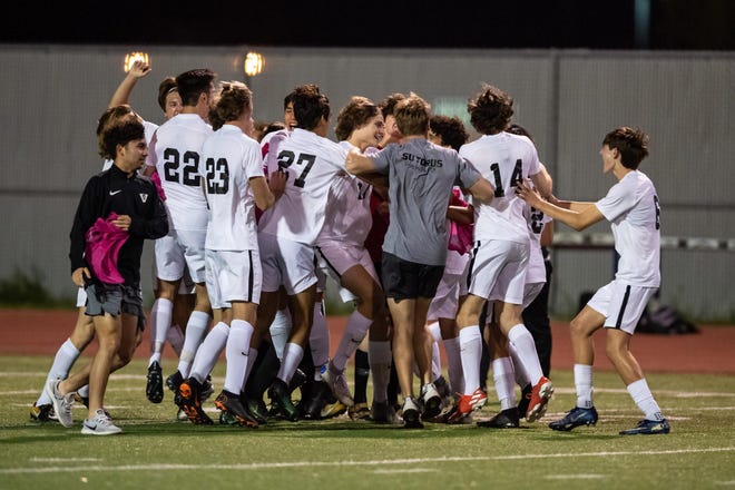 Vandegrift players celebrate claiming the District 13-6A title. Vandegrift won a district boys soccer match 3-1 on the road at Stony Point on March 13. [Henry Huey for Statesman]