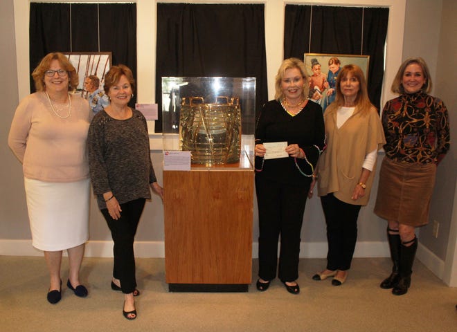 The Questers Chapter St. Johns #1281 from Ponte Vedra Beach donated $2,700 to the nonprofit St. Augustine Lighthouse & Maritime Museum. From left, Museum Executive Director Kathy A. Fleming, Museum Trustee Margaret Van Ormer, and Questers President Corrinne Martin, Treasurer Nancy Spadaro and Member Pam Korchun, all stand near the lightship lens in the WWII Coastal Looking Building on site at the St. Augustine Light Station. (Contributed photo)