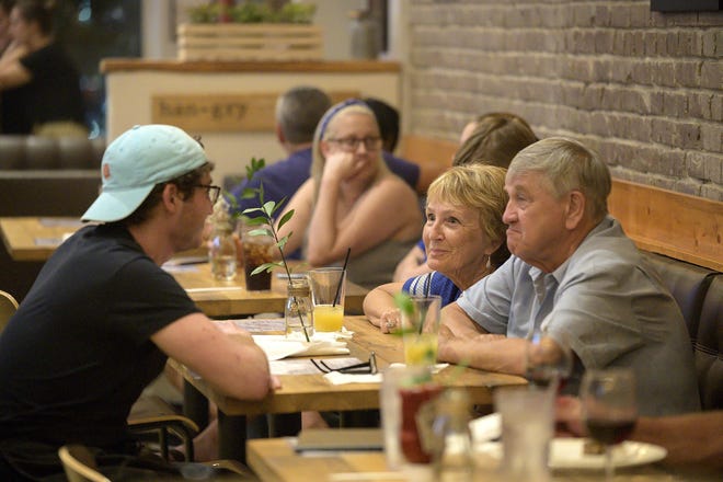 People socialize at The Brick and Barrel in downtown Leesburg. [Cindy Sharp/Correspondent]