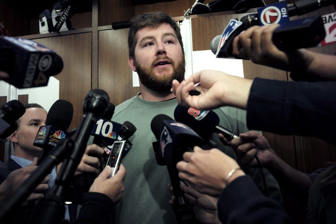 New England Patriots offensive guard Joe Thuney takes questions from reporters in the team's locker room following a practice on Sept. 18, 2019, in Foxborough. On Monday, the Patriots reportedly placed the franchise tag on Thuney. [AP File Photo/Steven Senne]