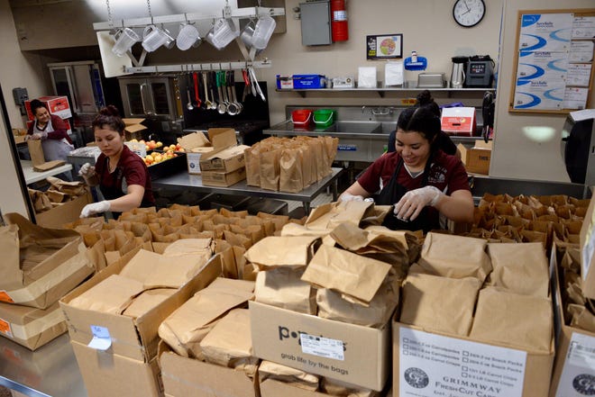 Oro Grande School District employees bag lunches for students despite the school being shutdown as the coronavirus continues to spread in Southern California. [PHOTO COURTESY OF KEVIN TRUDGEON]