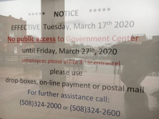 A sign on the door of One Government Center informs visitors the building is closed to the public Tuesday. [Herald News Photo | Jo C. Goode]
