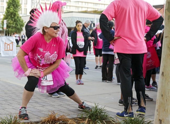 Cancer survivor Lori Ford stretches out before taking part in the 2016 Oklahoma City Susan G. Komen Race for the Cure at the Civic Center in Oklahoma City. [Chris Landsberger/The Oklahoman Archives]