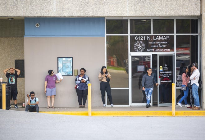 With no available seating inside Tuesday, customers wait outside the Texas Department of Public Safety driver’s license office on North Lamar Boulevard in Austin. Gov. Greg Abbott ordered all state driver’s license offices to close Wednesday night to avoid coronavirus exposure. [RICARDO B. BRAZZIELL/AMERICAN-STATESMAN]