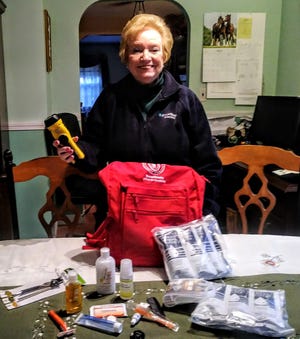 Gerri Butler, who helped organize an event for emergency preparedness in the fall, displays the pack full of items for an emergency given to the first 50 seniors and those with disabilities. [Courtesy photo]