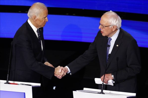 Democratic presidential candidates former Vice President Joe Biden, left, and Sen. Bernie Sanders, I-Vt., shake hands after a Jan. 14 Democratic presidential primary debate hosted by CNN and the Des Moines Register in Iowa. (AP Photo/Patrick Semansky)