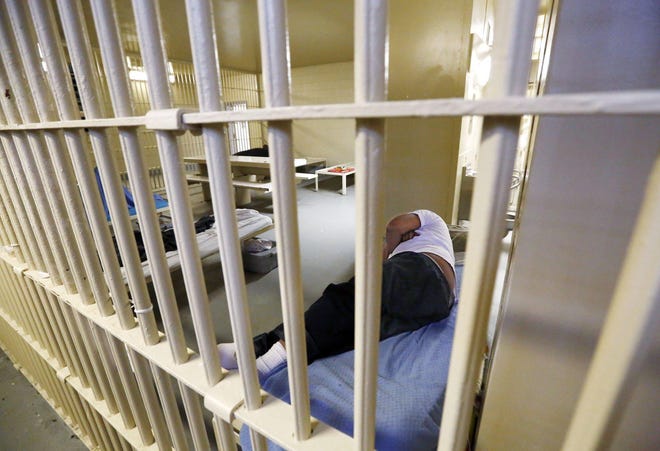 A prisoner sleeps in a cell on the medical floor of the Franklin County jail Downtown. Judges and law-enforcement officers are working together to reduce the inmate population in light of the coronavirus outbreak. [Fred Squillante /Dispatch]