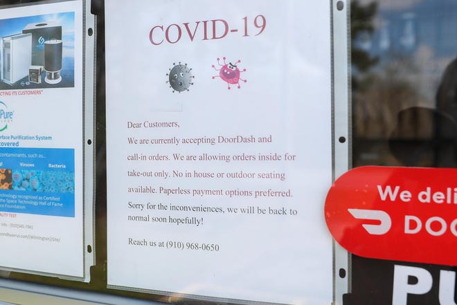 The Milk Road Cafe is open, but has a sign on their door letting customers know it’s take-out or DoorDash only at the moment. [Tina Brooks / The Daily News]