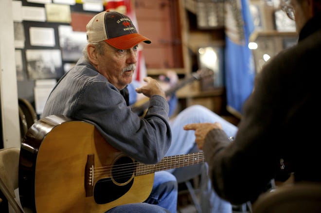 Joe Baxter with the Round Barn Ramblers talks with T.Z. Wright during a Morning Music Session inside the Arcadia Round Barn, Saturday, March 14, 2020. [Bryan Terry/The Oklahoman]