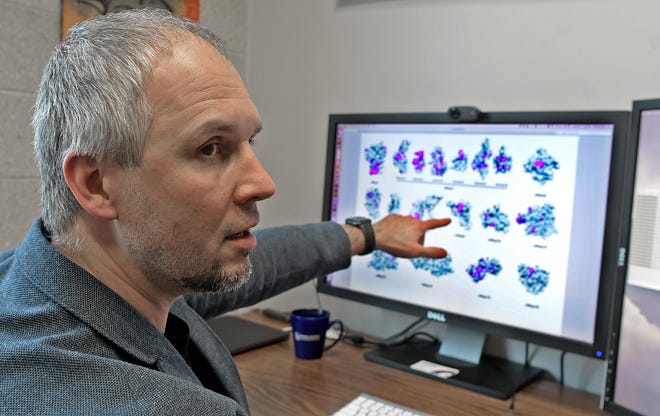 WPI professor Dmitry Korkin discusses mutations of the coronavirus, using a 3D roadmap model of the virus molecules, Tuesday in Worcester. [T&G Staff/Steve Lanava]