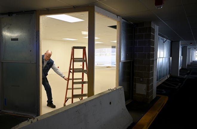 Joseph Boczanowski, director of facilities management at Milford Regional Medical Center, moves a ladder inside a 3,800-square-foot alternate care site under construction in preparation for a possible surge in patients to the emergency room Thursday. [Daily News and Wicked Local Staff Photo/Ken McGagh]