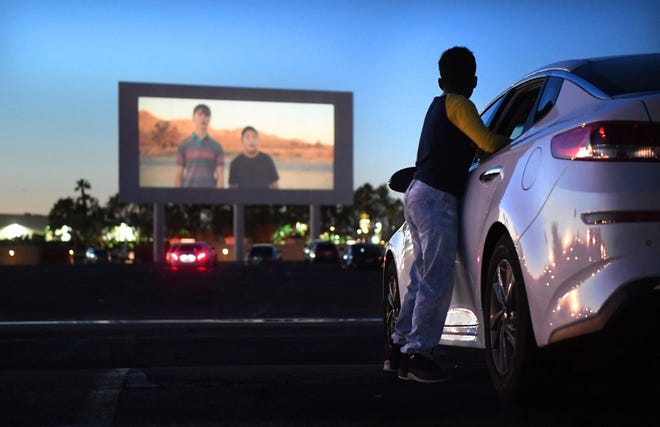 Michael Ray, 11, watches a trailer before a movie at the Paramount Drive-In on Tuesday, March 17, 2020. Some of the country's 305 drive-in theaters are experiencing a surge in interest amid the closure of other entertainment options because of social distancing efforts and governmental advisories during the coronavirus outbreak. (Wally Skalij/Los Angeles Times/TNS)