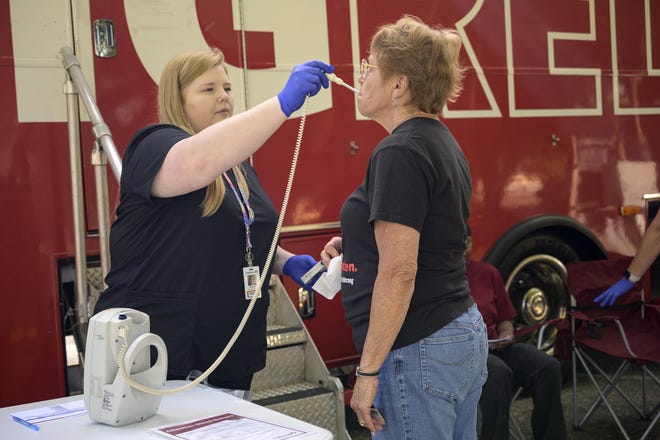 Mount Dora resident Janet Manchon gets her temperature checked before donating blood at OneBlood Big Red Bus in Mount Dora on Friday, March 20, 2020. [Cindy Sharp/Correspondent]