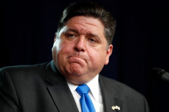 Illinois Gov. J.B. Pritzker listens to a question after announcing a shelter in place order to combat the spread of the Covid-19 virus, during a news conference Friday, March 20, 2020, in Chicago. (AP Photo/Charles Rex Arbogast)