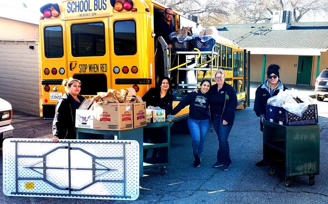 Victor Valley Union High School District employees post for a photo while loading 'grab-and-go' meals onto a bus in Victorville on Thursday, March 19, 2020. [PHOTO COURTESY OF VVUHSD]