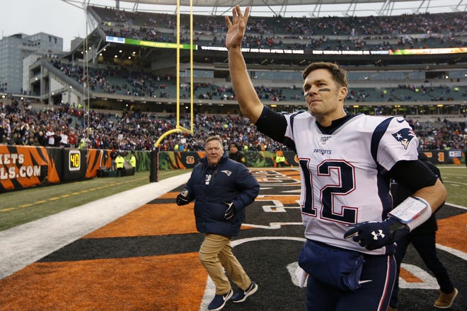 Former New England Patriots quarterback Tom Brady (12) waves to the crowd after a game against the Cincinnati Bengals in Cincinnati in December. [Frank Victores/AP]