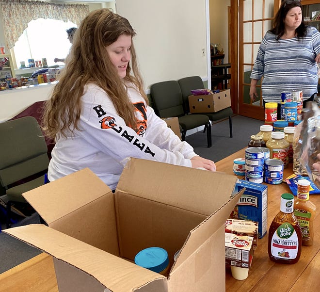 Home on break from college, Nicole Saunders helped her mother, Diana, who organized the food drive in the wake of the coronavirus school closures in Billerica.

[Courtesy Photo/Mary Leach]