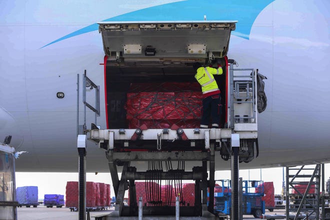 On Wednesday, a worker handles medical supplies mobilized by Chinese charities that are heading to France to help combat the coronavirus, at Liege airport, in Liege, Belgium. [Zheng Huansong/Xinhua News Agency]