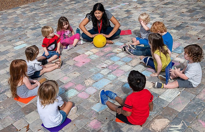 Gaby Bados works with children at the Lighthouse Prep preschool on Friday. [PETER WILLOTT/THE RECORD]
